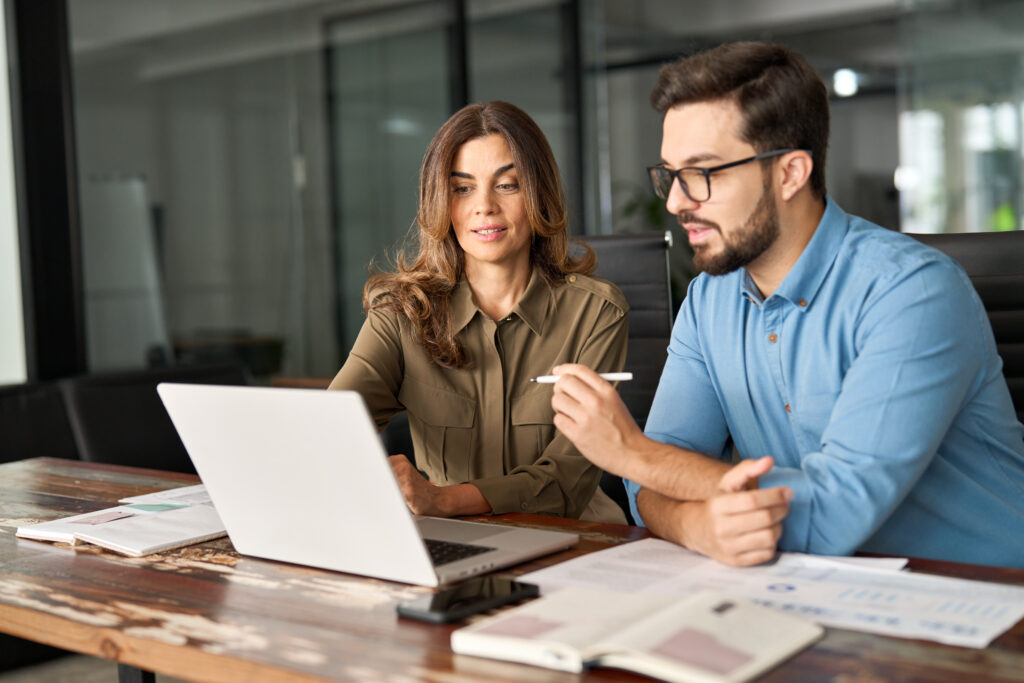 Two colleagues working together on their IT governance strategy